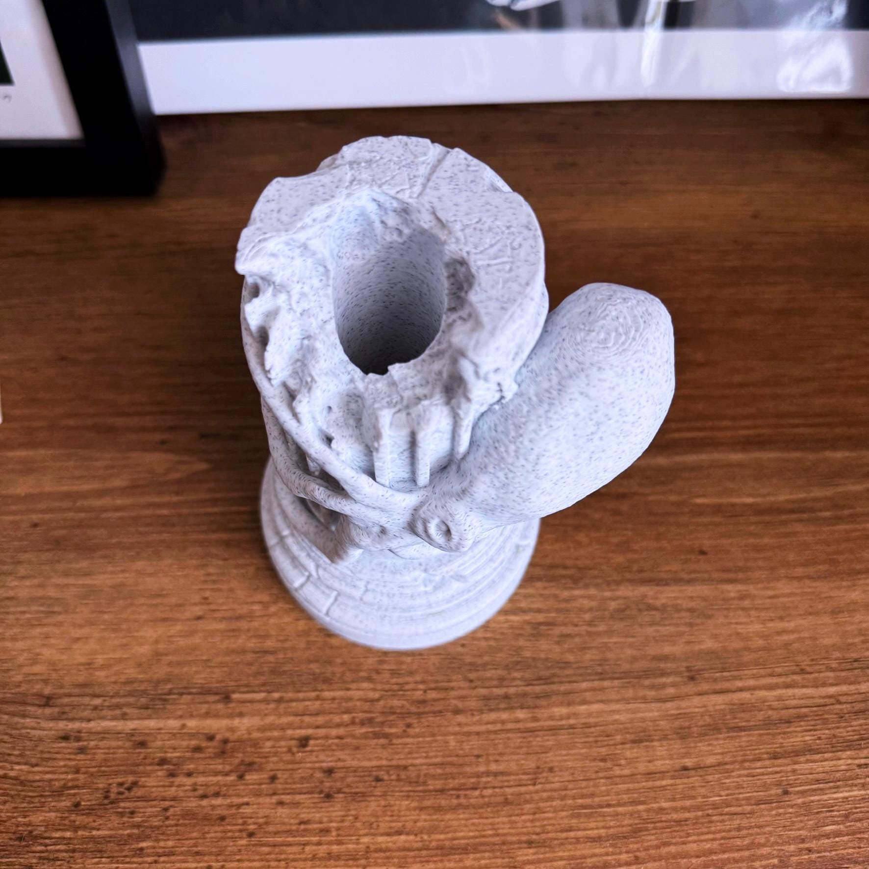 A propagation vase designed to look like a Greek Column with an Octopus wrapped around it