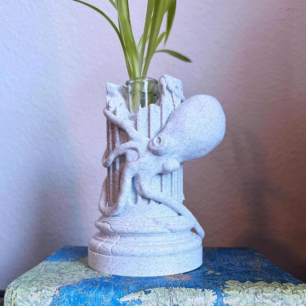 A propagation vase designed to look like a Greek Column with an Octopus wrapped around it