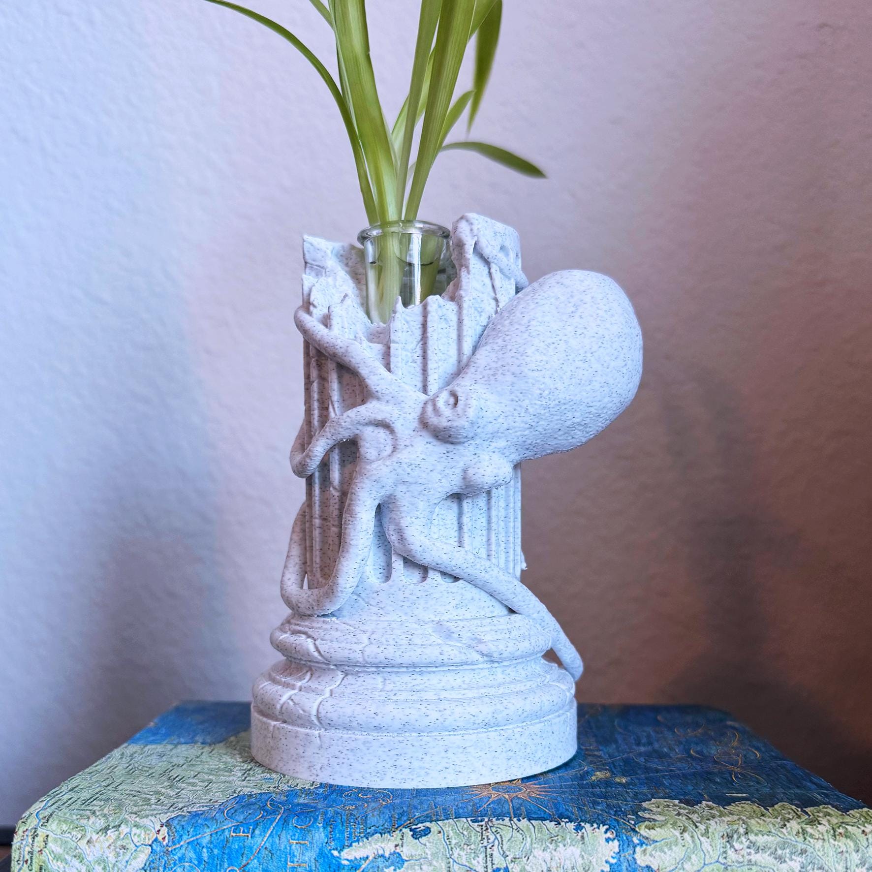A propagation vase designed to look like a Greek Column with an Octopus wrapped around it