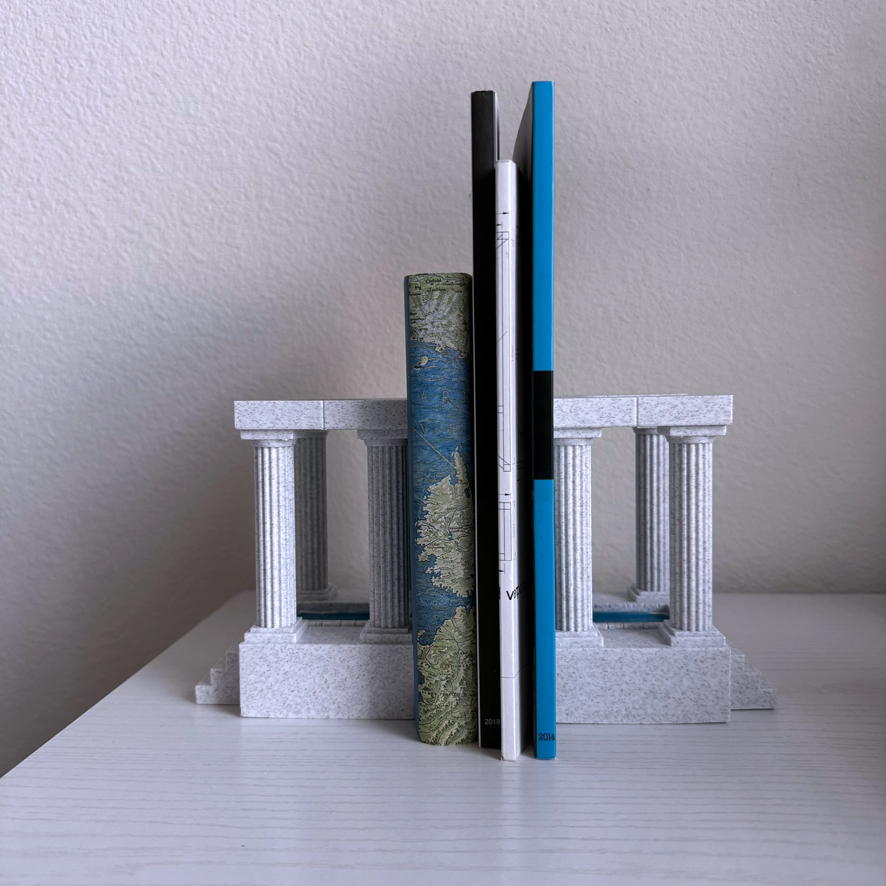 These 3d printed marble bookends are in the form of an ancient temple, with a pool at the center. These stately bookends elevate any bookshelf and add a classical flair. For lovers of antient architecture of Greece and Rome