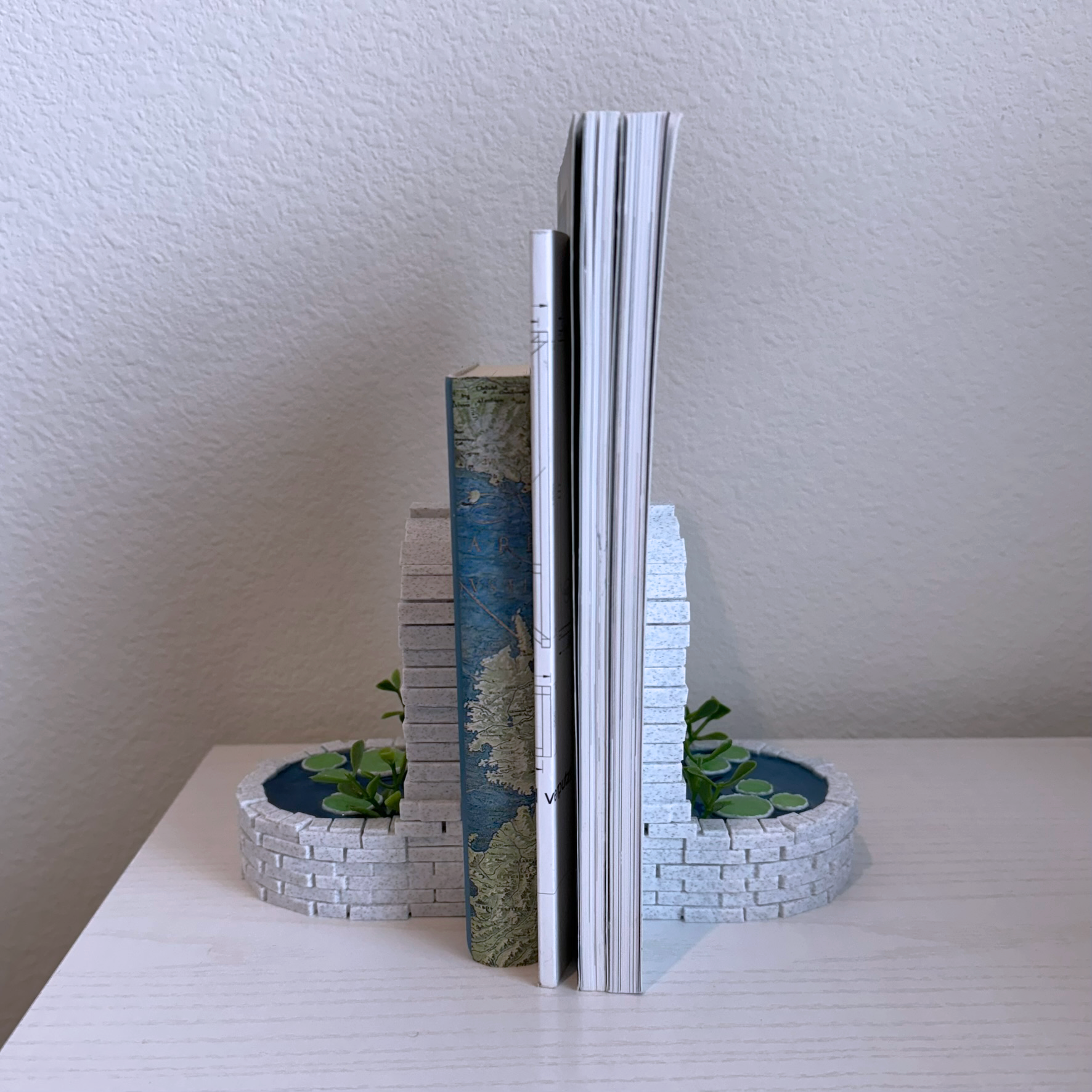 magical well pond bookend, 3d printed brick pond well with marble texture and resin water, lily pads and pond grass bookend. Cute, cool, unique bookend