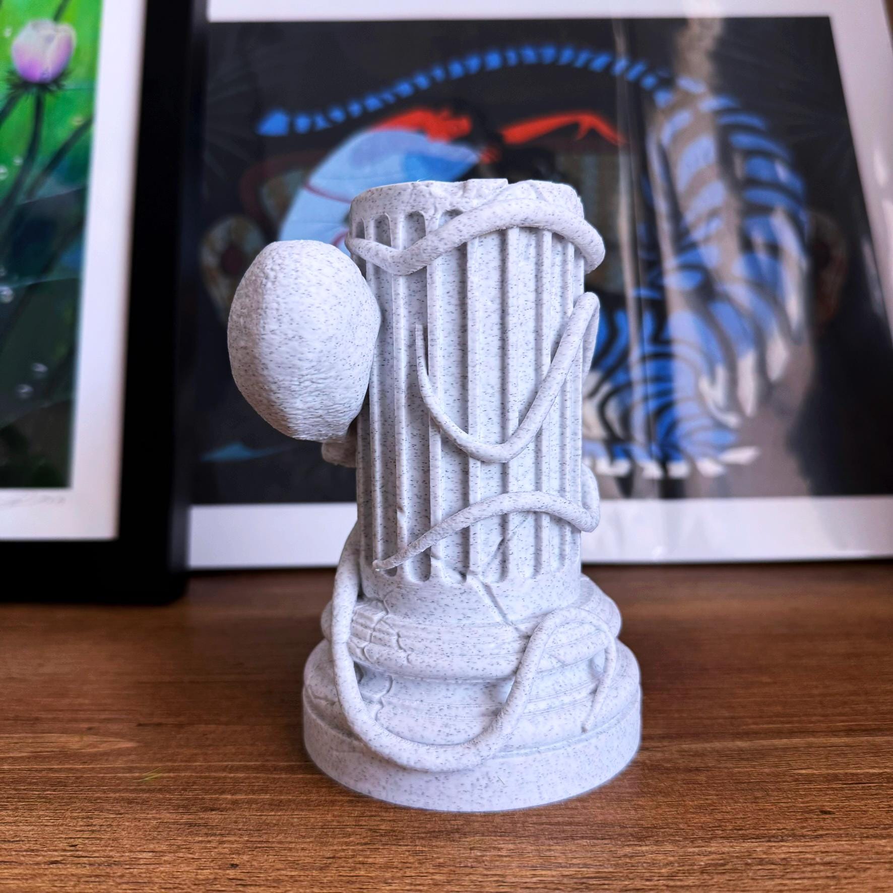 A propagation vase designed to look like a Greek Column with an Octopus wrapped around it